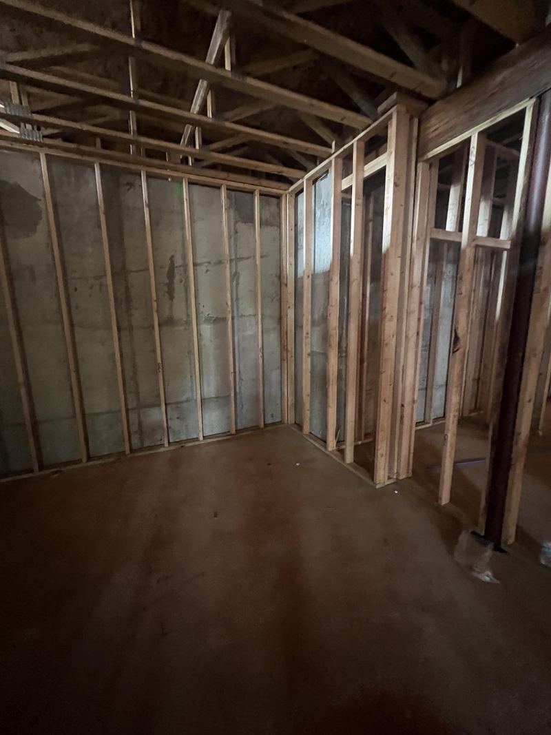 Example build style: simulator room at framing stage with open joists, showing where blocking, conduit, and circuits are planned before drywall
