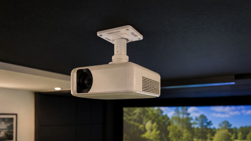 Example build style: ceiling-mounted projector detail in a simulator bay, cable-managed and positioned clear of the swing