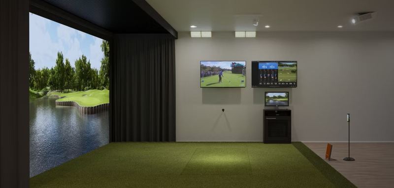 Example build style: simulator bay laid out for a radar-based launch monitor, with deep hitting area, impact screen, and open space behind the golfer