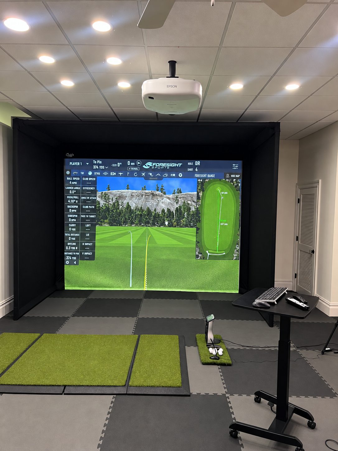 Foresight simulator enclosure with impact screen, ceiling projector and hitting area Completed Foresight golf simulator enclosure with overhead projection