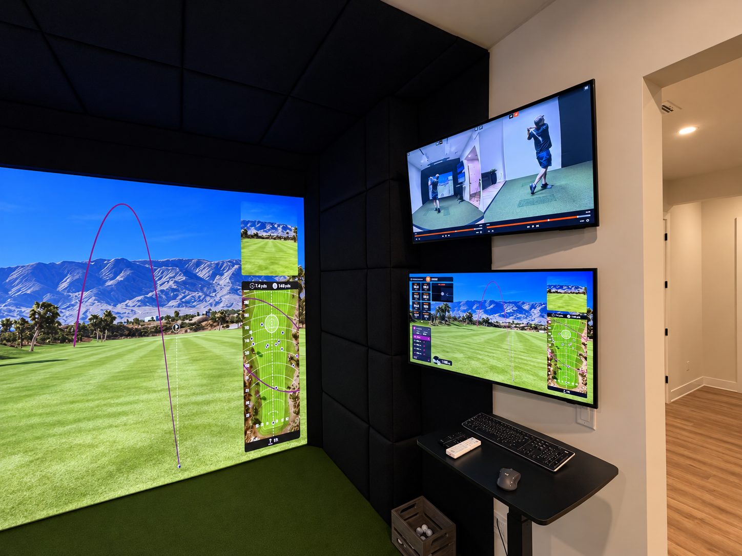 TrackMan simulator wall displays showing swing analysis and a projected golf course