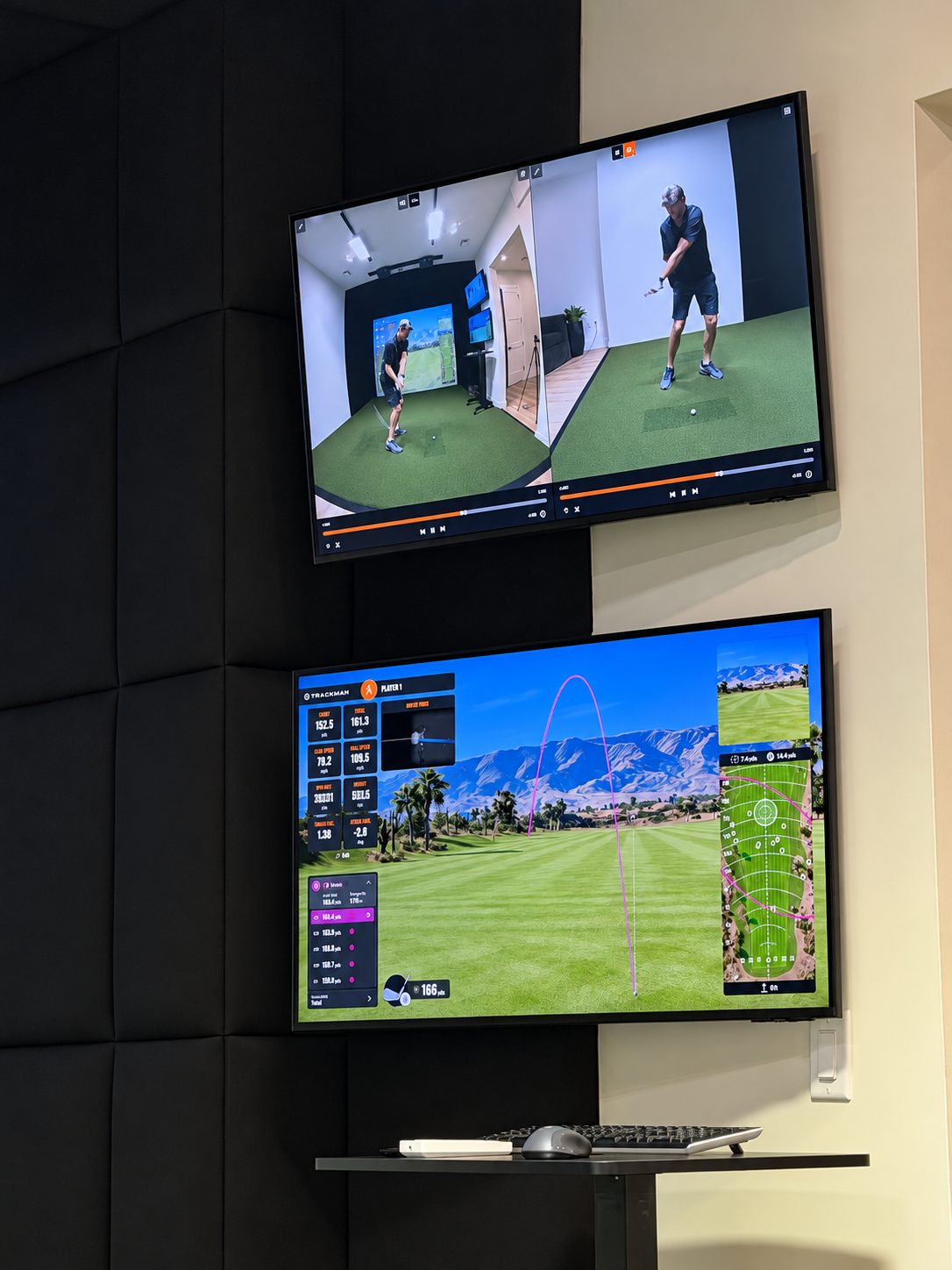 Close view of swing replay and shot data on wall-mounted simulator displays