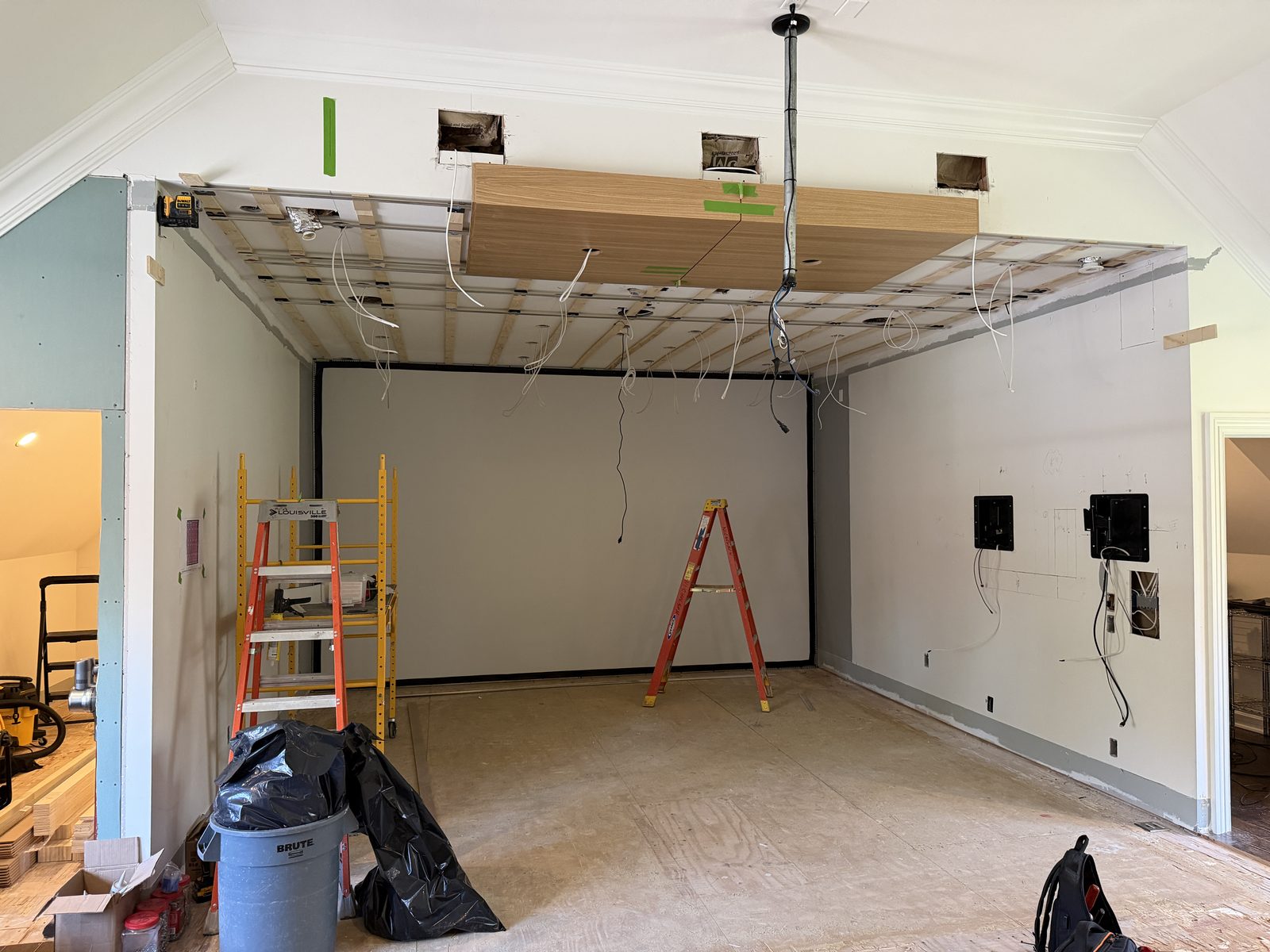 Golf simulator room during construction with ceiling and wiring work in progress